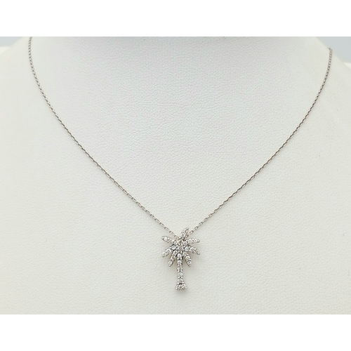 386 - An 18K WHITE GOLD DIAMOND SET PALM TREE PENDANT ON CHAIN 2.5G. Ref: TAN 7021