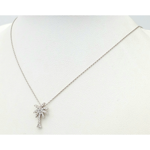 386 - An 18K WHITE GOLD DIAMOND SET PALM TREE PENDANT ON CHAIN 2.5G. Ref: TAN 7021