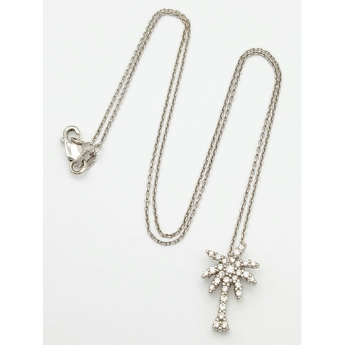 386 - An 18K WHITE GOLD DIAMOND SET PALM TREE PENDANT ON CHAIN 2.5G. Ref: TAN 7021