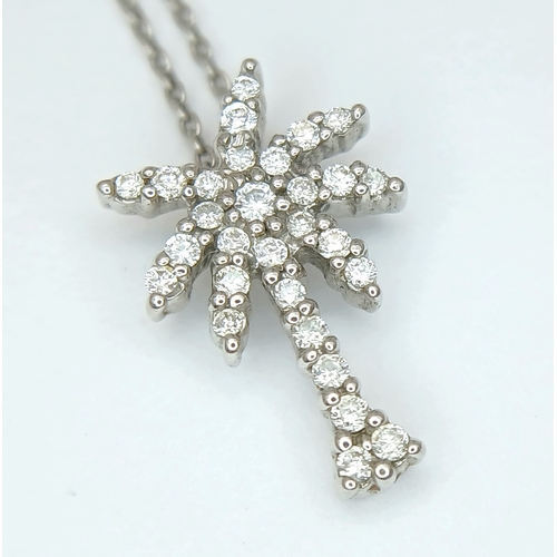386 - An 18K WHITE GOLD DIAMOND SET PALM TREE PENDANT ON CHAIN 2.5G. Ref: TAN 7021