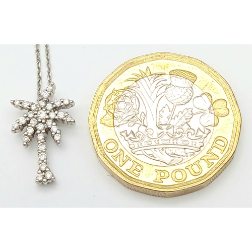386 - An 18K WHITE GOLD DIAMOND SET PALM TREE PENDANT ON CHAIN 2.5G. Ref: TAN 7021