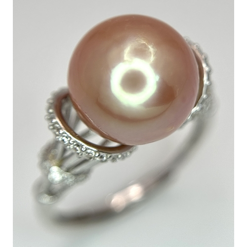528 - A 925 Silver Cultured Pearl and CZ Ring. Featuring a beautiful rose gold cultured pearl accented by ... 