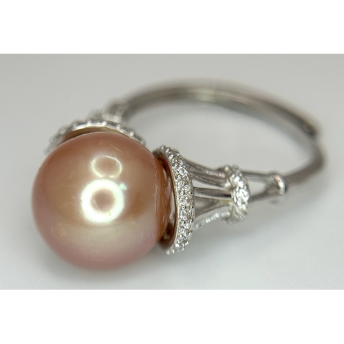 528 - A 925 Silver Cultured Pearl and CZ Ring. Featuring a beautiful rose gold cultured pearl accented by ... 