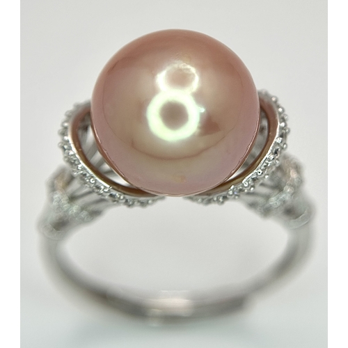 528 - A 925 Silver Cultured Pearl and CZ Ring. Featuring a beautiful rose gold cultured pearl accented by ... 