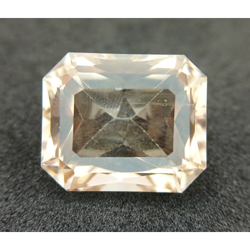 751 - A 24.40CT NATURAL PEACH/PINK TOPAZ EMERALD CUT . Ref: MGB 7002