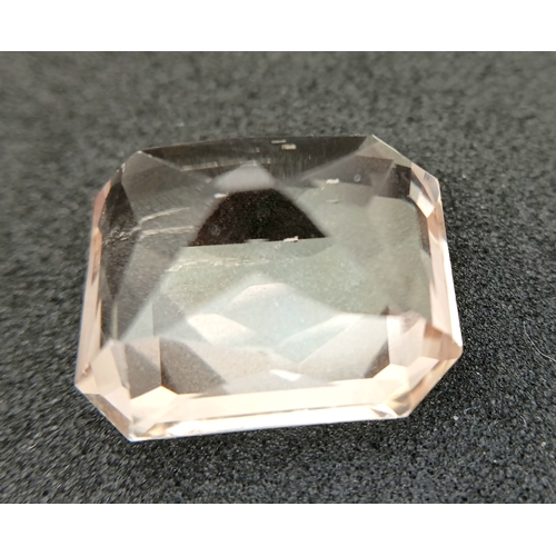 751 - A 24.40CT NATURAL PEACH/PINK TOPAZ EMERALD CUT . Ref: MGB 7002