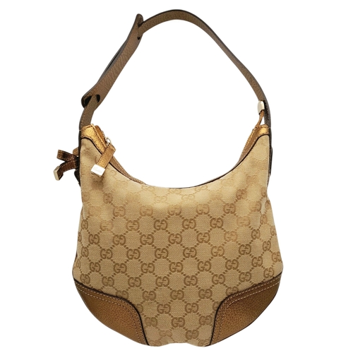 601 - A Gucci Monogram Princy Hobo Bag. Canvas exterior with metallic leather trim, single strap, silver-t... 