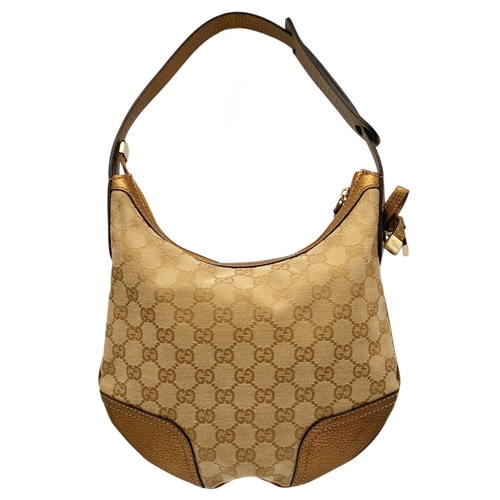 601 - A Gucci Monogram Princy Hobo Bag. Canvas exterior with metallic leather trim, single strap, silver-t... 