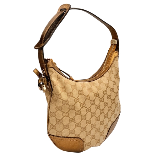 601 - A Gucci Monogram Princy Hobo Bag. Canvas exterior with metallic leather trim, single strap, silver-t... 
