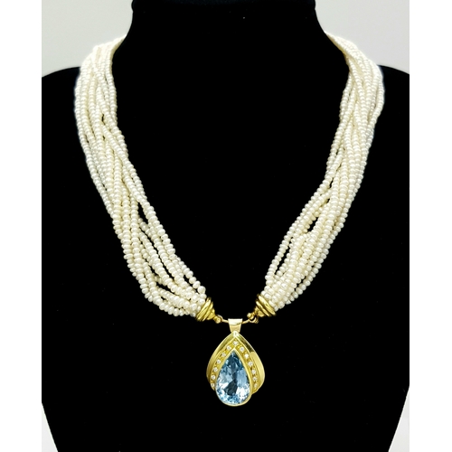 26 - A MULTISTRAND FRESHWATER PEARL NECKLACE WITH 18K YELLOW PENDANT CLASP SET WITH DIAMONDS AND BLUE TOP... 