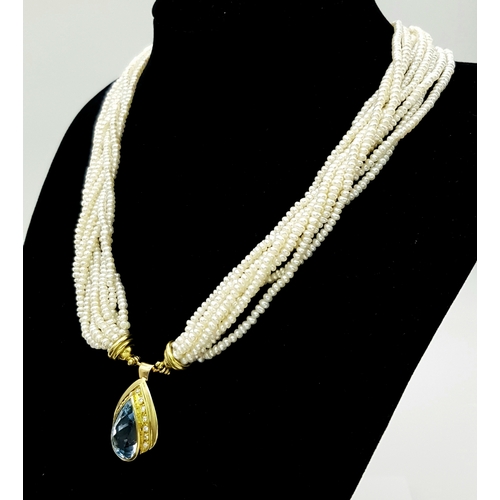 26 - A MULTISTRAND FRESHWATER PEARL NECKLACE WITH 18K YELLOW PENDANT CLASP SET WITH DIAMONDS AND BLUE TOP... 