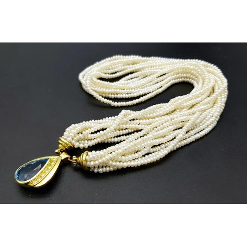 26 - A MULTISTRAND FRESHWATER PEARL NECKLACE WITH 18K YELLOW PENDANT CLASP SET WITH DIAMONDS AND BLUE TOP... 