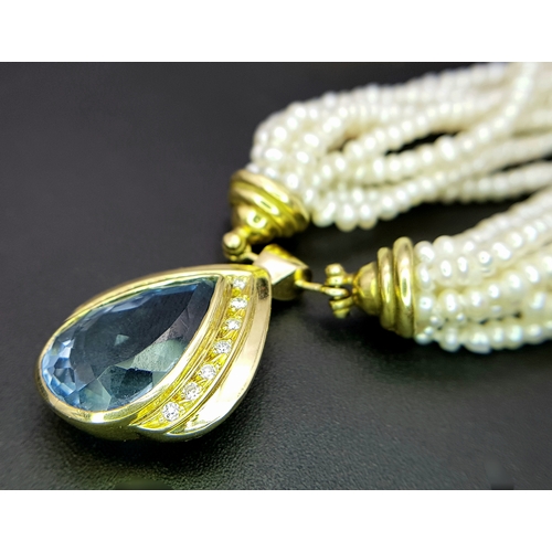 26 - A MULTISTRAND FRESHWATER PEARL NECKLACE WITH 18K YELLOW PENDANT CLASP SET WITH DIAMONDS AND BLUE TOP... 