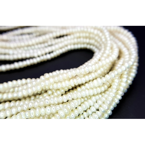 26 - A MULTISTRAND FRESHWATER PEARL NECKLACE WITH 18K YELLOW PENDANT CLASP SET WITH DIAMONDS AND BLUE TOP... 