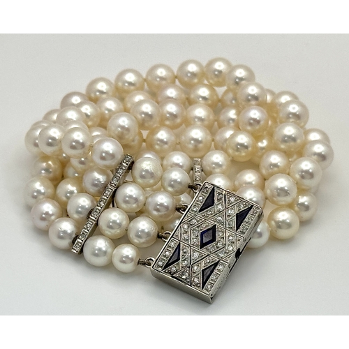 47 - A FOUR ROW AKOYA PEARL BRACELET WITH A 14K WHITE GOLD DIAMOND AND SAPPHIRE SET CLASP. A BEAUTIFUL PI... 