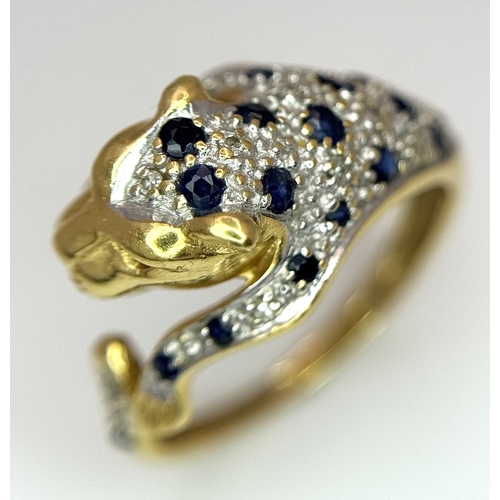 54 - An 18K YELLOW GOLD DIAMOND AND SAPPHIRE SET PANTHER RING. ONE STONE MISSING. 4.6G SIZE L. Ref: 9983