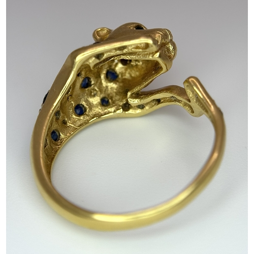 54 - An 18K YELLOW GOLD DIAMOND AND SAPPHIRE SET PANTHER RING. ONE STONE MISSING. 4.6G SIZE L. Ref: 9983