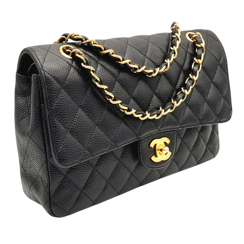 55 - A Chanel Black Caviar Leather Classic Double Flap Bag. Black caviar leather exterior with gold-toned... 