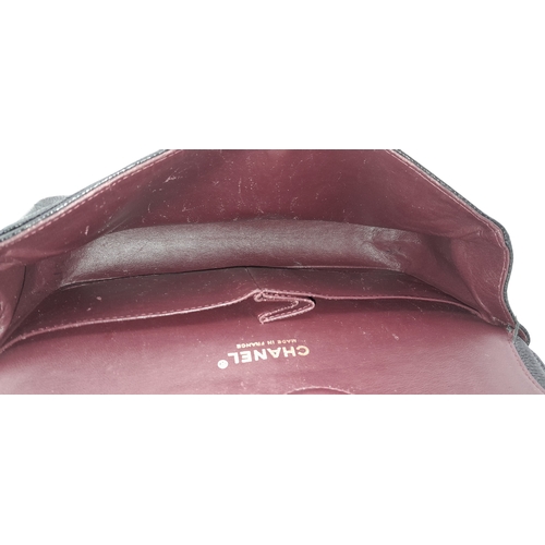 55 - A Chanel Black Caviar Leather Classic Double Flap Bag. Black caviar leather exterior with gold-toned... 