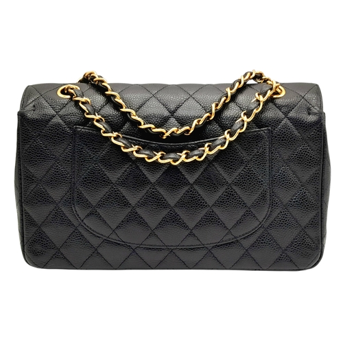 55 - A Chanel Black Caviar Leather Classic Double Flap Bag. Black caviar leather exterior with gold-toned... 