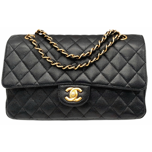 55 - A Chanel Black Caviar Leather Classic Double Flap Bag. Black caviar leather exterior with gold-toned... 
