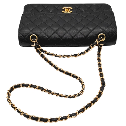 55 - A Chanel Black Caviar Leather Classic Double Flap Bag. Black caviar leather exterior with gold-toned... 