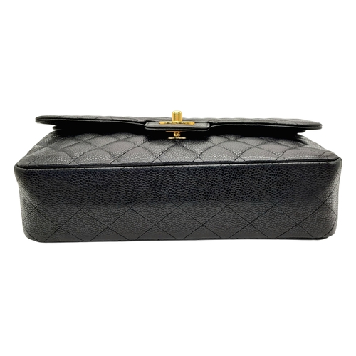55 - A Chanel Black Caviar Leather Classic Double Flap Bag. Black caviar leather exterior with gold-toned... 
