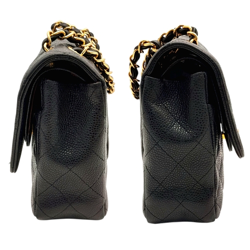55 - A Chanel Black Caviar Leather Classic Double Flap Bag. Black caviar leather exterior with gold-toned... 