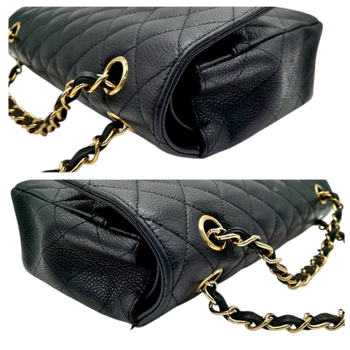 55 - A Chanel Black Caviar Leather Classic Double Flap Bag. Black caviar leather exterior with gold-toned... 