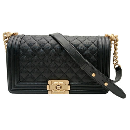 A Chanel Black Caviar Quilted Boy Bag. Black leather exterior with gold-tone hardware, chunky chain-and-leather strap and push-lock closure. Black leather interior with a single main compartment and one slip pocket. Some scratches to the hardware and some signs of wear to the exterior. Approx 25cm length × 15cm height × 4cm depth. Comes with COA and an original dust cover. Please see photos or request a condition report.  STK025749