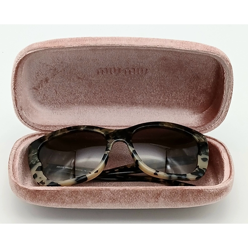 488 - A Pair of Miu Miu Designer Ladies Sunglasses. Comes with original box.  STK025780
