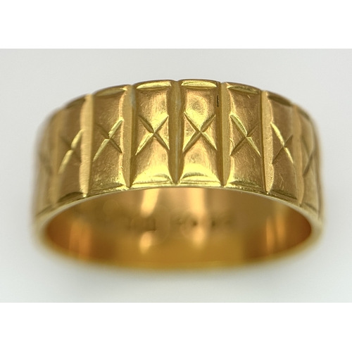 58 - A 22K GOLD BAND RING WITH THE X FACTOR DECORATION .    5.3gms    size J