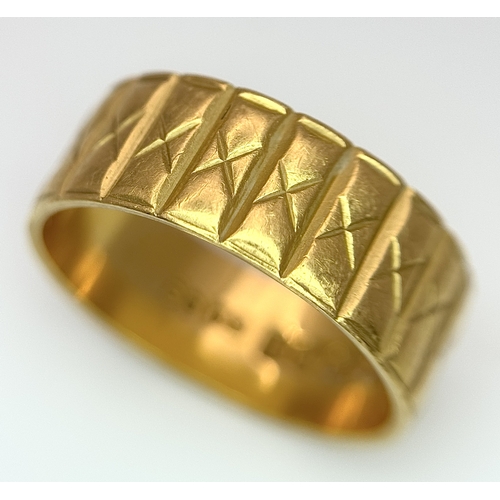 58 - A 22K GOLD BAND RING WITH THE X FACTOR DECORATION .    5.3gms    size J