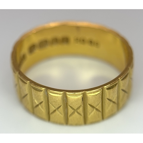 58 - A 22K GOLD BAND RING WITH THE X FACTOR DECORATION .    5.3gms    size J