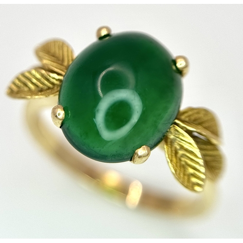 10 - AN 18K GOLD DESIGNER RING WITH A CENTRAL JADE CABOCHON CLAW SET .     4.3gms    size O