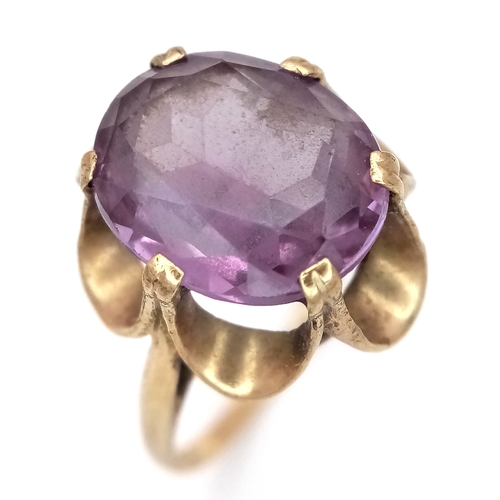 212 - A LARGE AQUAMARINE COLOURED STONE SET IN AN ORNATE 9K GOLD VINTAGE RING .       3.7gms    size N/O