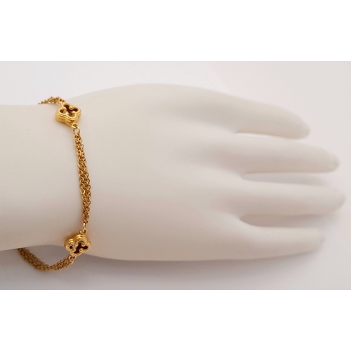 1323 - 18K YELLOW GOLD 2 STRAND CLOVER DESIGN BRACELET 4.2G. REF: TAN 6020