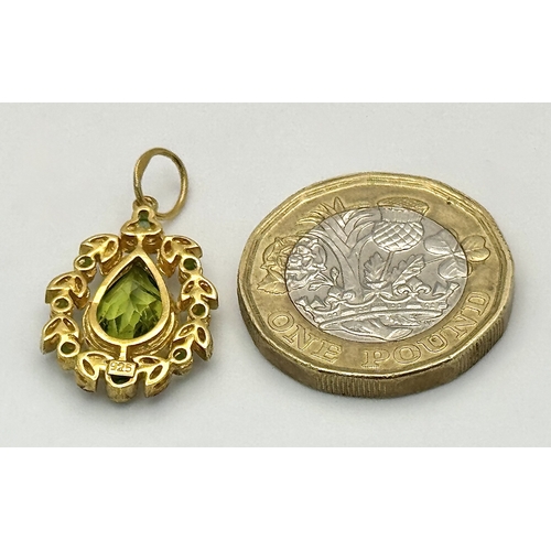 1732 - A Gilt Sterling Silver Pendant with: 1.5ct peridot, 0.12ctw diamonds and 0.18ctw emeralds. 14k gold ... 
