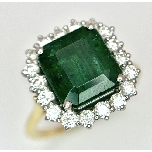 1298 - A W.G.I Certified 18K Yellow Gold, 950 Platinum, Emerald and Diamond Ring. An octagonal cut 4.05ct e... 