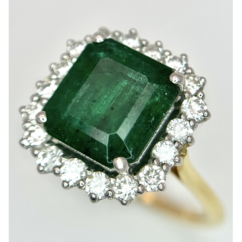 1298 - A W.G.I Certified 18K Yellow Gold, 950 Platinum, Emerald and Diamond Ring. An octagonal cut 4.05ct e... 