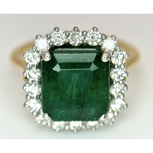 1298 - A W.G.I Certified 18K Yellow Gold, 950 Platinum, Emerald and Diamond Ring. An octagonal cut 4.05ct e... 
