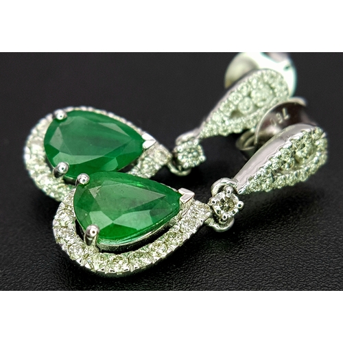 1410 - A Pair of 18K White Gold, Colombian Emerald and Diamond Drop Earrings. Each having a 1ct emerald wit... 
