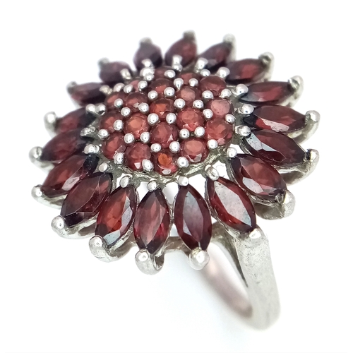 1707 - A STERLING SILVER GARNET SET CLUSTER RING. 5.1G. SIZE N. SC6108.