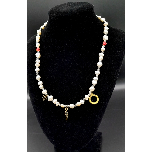 1489 - A pretty Freshwater Pearl link T-bar necklace with enamelled charms. Total length 48cm.