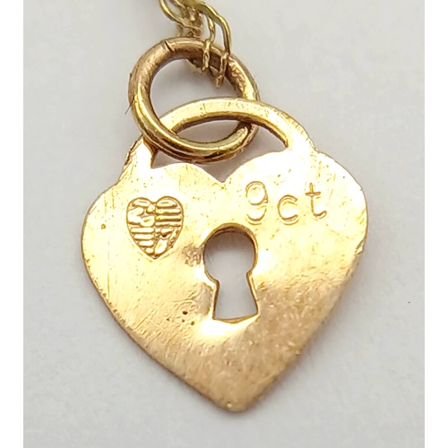 21 - 9 CARAT GOLD FINE CHAIN BRACELET with CHARM. 0.5 Grams . 17 cm.