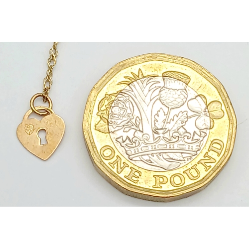 21 - 9 CARAT GOLD FINE CHAIN BRACELET with CHARM. 0.5 Grams . 17 cm.