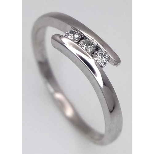 1717 - A Platinum Diamond Trilogy Ring. 2.9g total weight. 0.06ctw diamonds. Ring size M. Ref: 6783H