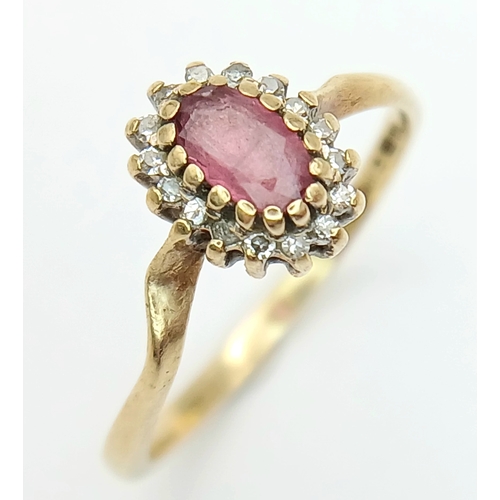 566 - A 9K Yellow Gold Ruby and Diamond Surround Ring. Size K. 1.3g.