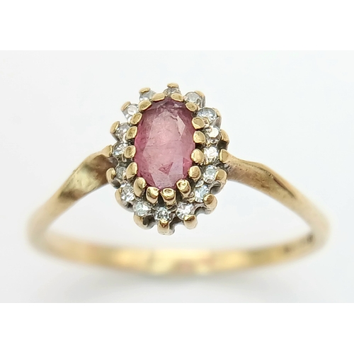 566 - A 9K Yellow Gold Ruby and Diamond Surround Ring. Size K. 1.3g.