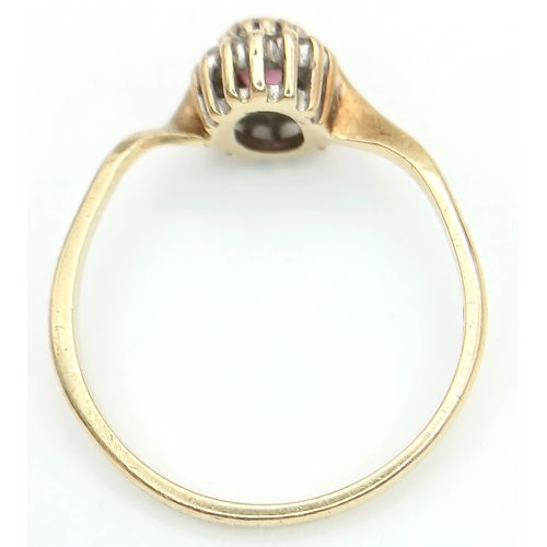 566 - A 9K Yellow Gold Ruby and Diamond Surround Ring. Size K. 1.3g.